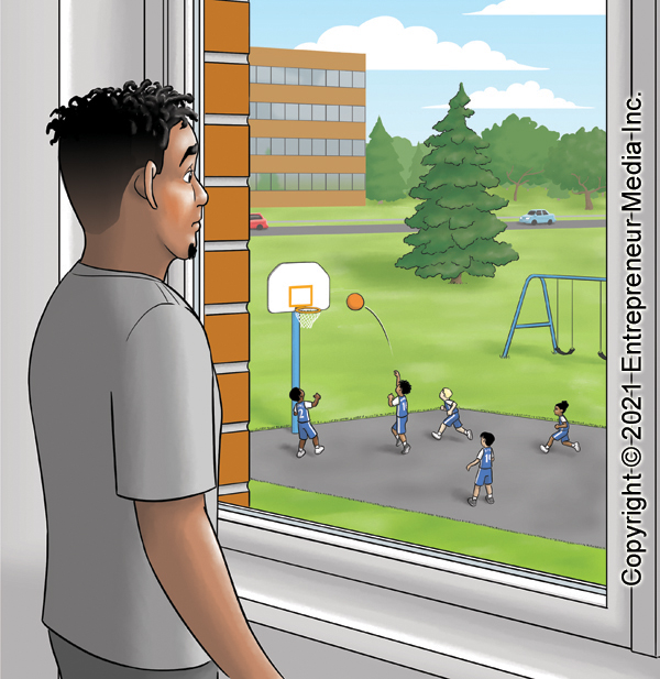 The coach stands inside a brick building, looking out the window.  Outside, the Sea Turtles youth basketball team practices on the blacktop court on the playground.  